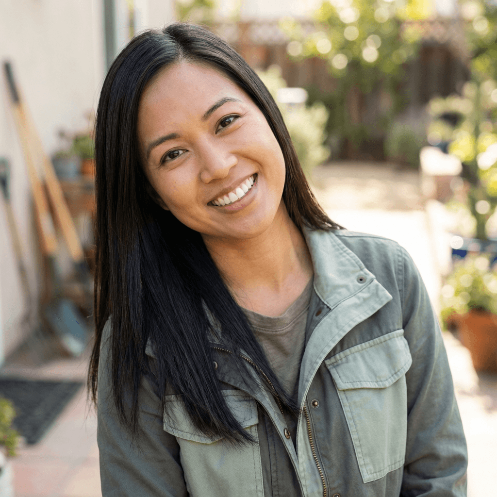 Female homeowner in her early 30s, white, friendly relaxed smile in a bright kitchen